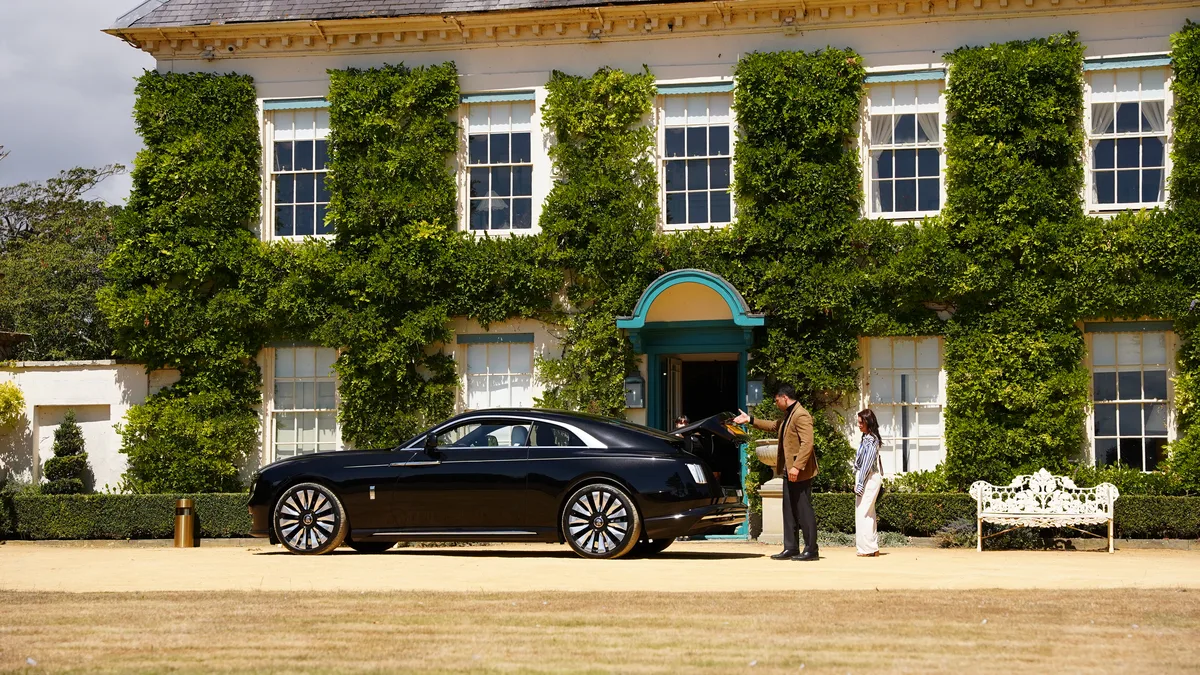 Filming outside an ivy-covered manor house